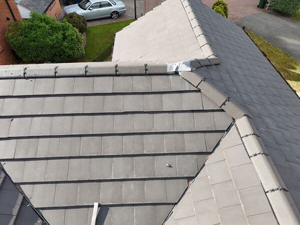Roof overview photo showing tiled sections, ridges and neighbouring access from above.