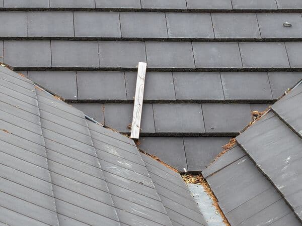 Close aerial view of a tiled roof valley between two pitches, where debris tends to collect.